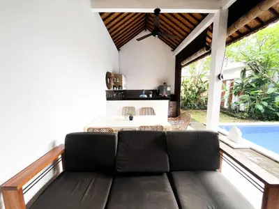 a living room with a couch and a table at Villa Sayang 2 in Seminyak