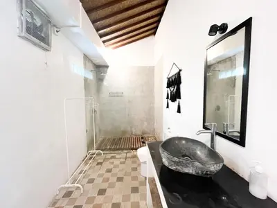 a bathroom with a sink and a mirror at Villa Sayang 2 in Seminyak