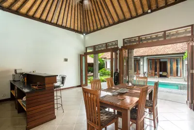 a kitchen and dining room with a table and chairs at Lacita Villa Seminyak in Seminyak