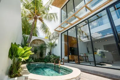 a house with a hot tub in a courtyard at Villa Casa Goya - Lofty Pool Villa Near The Beach in Vibrant Legian in Legian