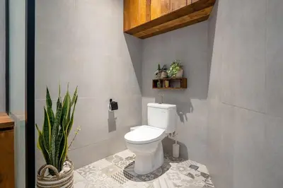 a bathroom with a toilet and a potted plant at Villa Casa Goya - Lofty Pool Villa Near The Beach in Vibrant Legian in Legian