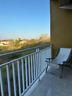 a bench sitting on the balcony of a building at Rumah Jimbaran Kuta 2 bedroom 6 pax SukaBali 5 in Jimbaran
