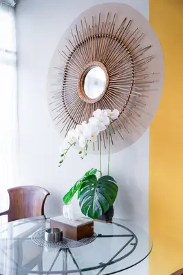 a mirror on a wall above a glass table at Rumah Jimbaran Kuta 2 bedroom 6 pax SukaBali 5 in Jimbaran