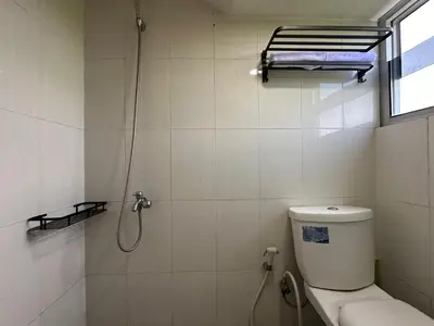 a small bathroom with a toilet and a shower at Rumah Jimbaran Kuta 2 bedroom 6 pax SukaBali 5 in Jimbaran