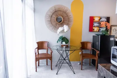 a dining room with a glass table and chairs at Rumah Jimbaran Kuta 2 bedroom 6 pax SukaBali 5 in Jimbaran