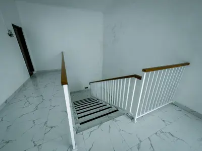a stairwell with a white railing and a white floor at Pachira Living Legian in Legian