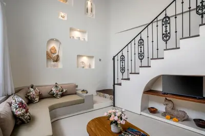 a living room with a couch and a tv at Villa Umabell Villa Seminyak in Seminyak