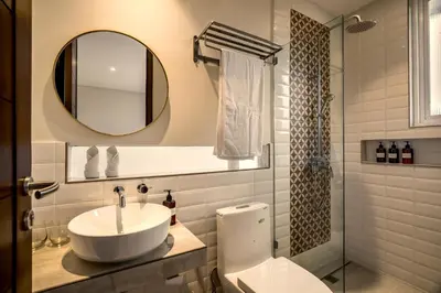 a bathroom with a sink and a toilet and a mirror at Villa Umabell Villa Seminyak in Seminyak