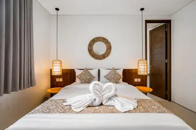 a bedroom with a bed with white towels on it at Villa Umabell Villa Seminyak in Seminyak