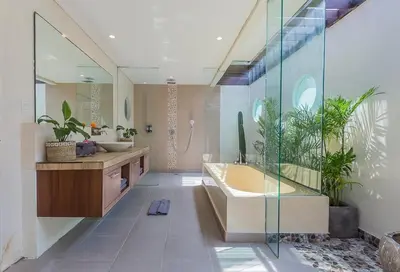 a bathroom with a tub and two sinks and plants at Luxury 4 Bedroom Villa Seminiak in Seminyak