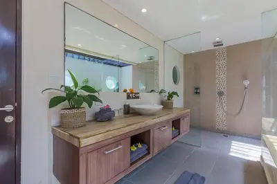 a bathroom with a sink and a mirror at Luxury 4 Bedroom Villa Seminiak in Seminyak