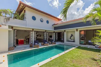 a villa with a swimming pool and a house at Luxury 4 Bedroom Villa Seminiak in Seminyak