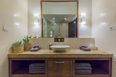 a bathroom with a sink and a large mirror at Luxury 4 Bedroom Villa Seminiak in Seminyak