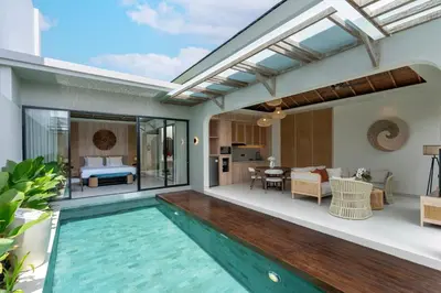 a villa with a swimming pool and a living room at Deneva Villa by Betterplace in Canggu
