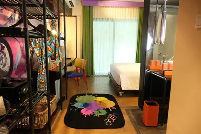 a room with a bedroom with a bed and a rug at Viva Dash Hotel Seminyak in Seminyak