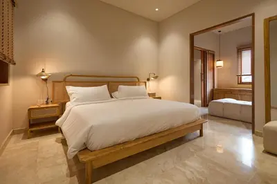 a bedroom with a large white bed and a mirror at Fale Seminyak - Brand New Modern Luxury 5BR Villa in Seminyak with Private Pool, Gym & Massage Room in Seminyak