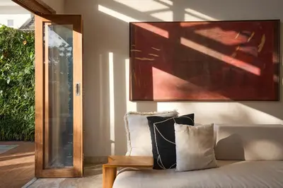 a bedroom with a couch and a painting on the wall at Fale Seminyak - Brand New Modern Luxury 5BR Villa in Seminyak with Private Pool, Gym & Massage Room in Seminyak