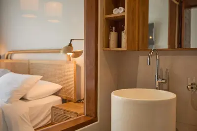 a bathroom with a sink and a mirror next to a bed at Fale Seminyak - Brand New Modern Luxury 5BR Villa in Seminyak with Private Pool, Gym & Massage Room in Seminyak