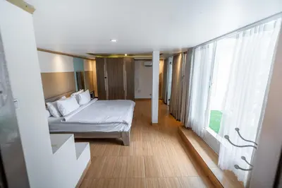 a bedroom with a bed and a large window at House Jimbaran Kuta 3 bedroom 8 pax SukaBali 6 in Jimbaran