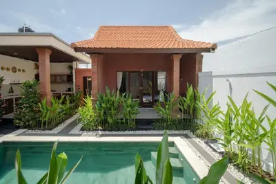 a house with a swimming pool in front of it at Villa Moza in Canggu
