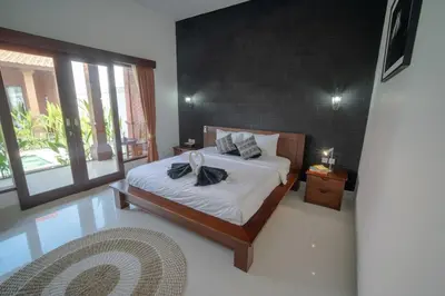a bedroom with a bed with two towels on it at Villa Moza in Canggu