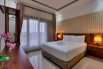 a bedroom with a large bed and a large window at Villa Taman Seminyak 44 near Double Six Beach in Seminyak