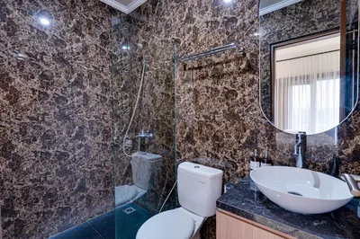 a bathroom with a toilet and a sink and a mirror at Villa Taman Seminyak 44 near Double Six Beach in Seminyak