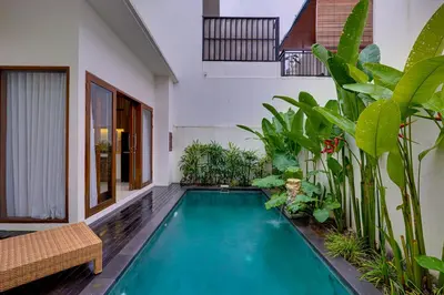 a swimming pool in the middle of a house with plants at Villa Taman Seminyak 44 near Double Six Beach in Seminyak