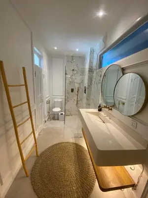 a bathroom with a sink and a mirror at Ara Santvana Villa Bali in Legian
