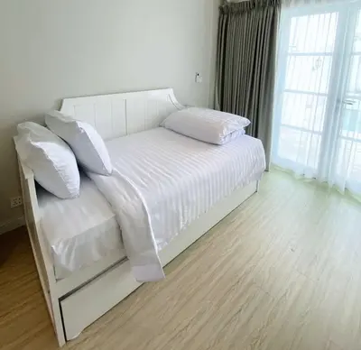a bedroom with a white bed with white sheets and pillows at Ara Santvana Villa Bali in Legian