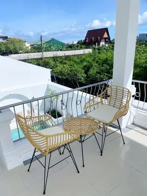 two chairs and a table on a balcony at Ara Santvana Villa Bali in Legian