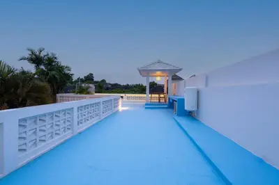 a balcony of a house with blue lighting at Villa Bali Road House Seminyak in Seminyak