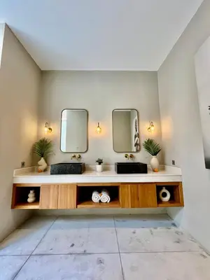 a bathroom with two sinks and two mirrors at 2 BR Villa Near Seminyak Beach in Seminyak