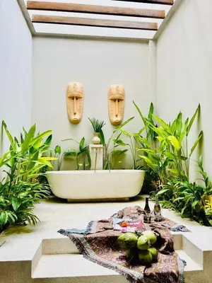 a bathroom with a bath tub and plants at 2 BR Villa Near Seminyak Beach in Seminyak