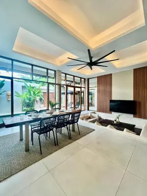 a living room with a dining table and a ceiling fan at 2 BR Villa Near Seminyak Beach in Seminyak