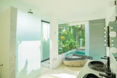 a bathroom with a tub and a swimming pool at Villa Sassy - Stunning Private Award Winning Seminyak Oasis in Seminyak