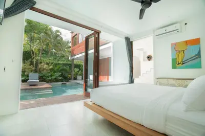 a bedroom with a large bed and a swimming pool at Villa Sassy - Stunning Private Award Winning Seminyak Oasis in Seminyak