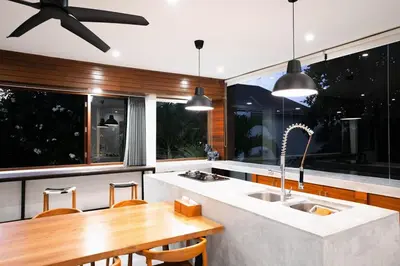 a kitchen with a sink and a wooden table at Villa Sassy - Stunning Private Award Winning Seminyak Oasis in Seminyak