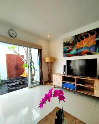 a living room with a large flat screen tv at Bluna Villa seminyak in Seminyak