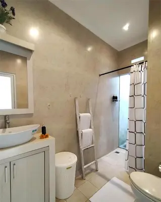 a bathroom with a sink and a glass shower at Bluna Villa seminyak in Seminyak