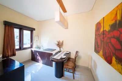 a room with a desk and a painting on the wall at The Mupu Seminyak in Seminyak