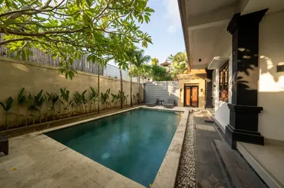 a swimming pool in the backyard of a house at The Mupu Seminyak in Seminyak