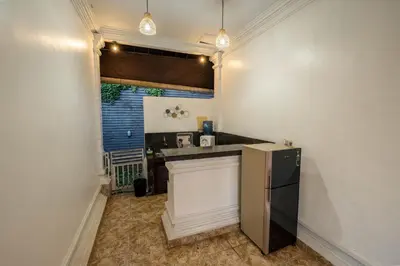 a small kitchen with a refrigerator in a room at The Mupu Villa Seminyak in Seminyak
