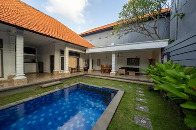 a swimming pool in the backyard of a house at The Mupu Villa Seminyak in Seminyak