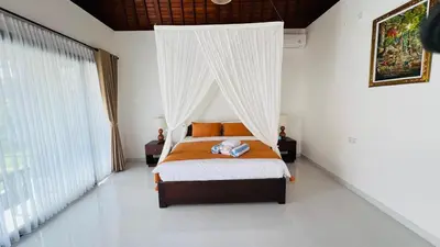 a bedroom with a bed with a canopy at UCU VILLAGE at ULUWATU JIMBARAN in Jimbaran
