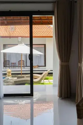 a view of a patio from a house through a glass door at UCU VILLAGE at ULUWATU JIMBARAN in Jimbaran