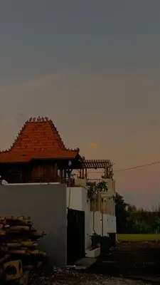 a building with an orange roof and a building at Wakajima House kuta Utara in Kerobokan