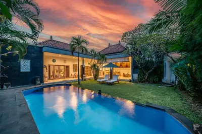 a villa with a swimming pool in the yard at Villa Kangaroo Seminyak next to double six beach in Seminyak
