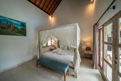 a bedroom with a bed with a canopy at Villa Kangaroo Seminyak next to double six beach in Seminyak