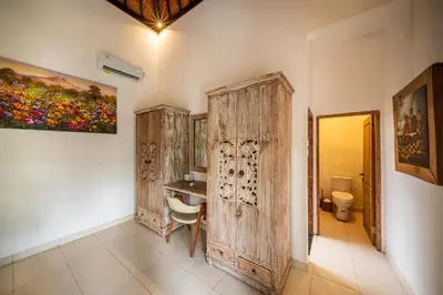 a room with a desk and a painting on the wall at Villa Kangaroo Seminyak next to double six beach in Seminyak